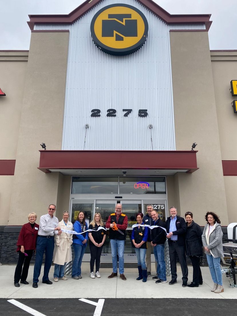 Group having ribbon cutting at Northern Tool + Equipment